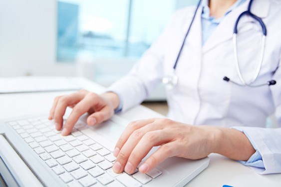medical worker typing on a laptop