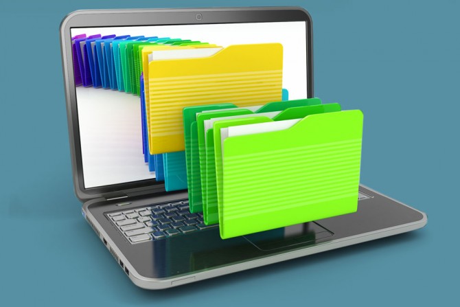 Laptop computer with file folders coming out of the screen representing many storage options.