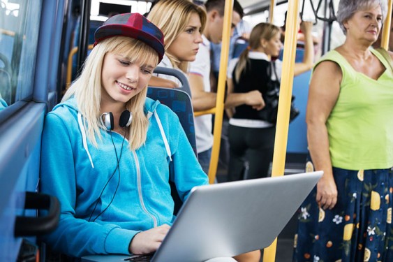 Girl on bus with laptop