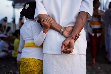 Small child in vivid yellow skirt grasps her grandparent's forearm. Photo credit @immo_cb on Instagram